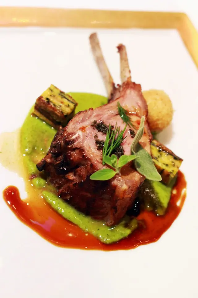 Organic lamb chops and Mediterranean fresh herbs, zucchini “millefoglie” and candied tomatoes croque
