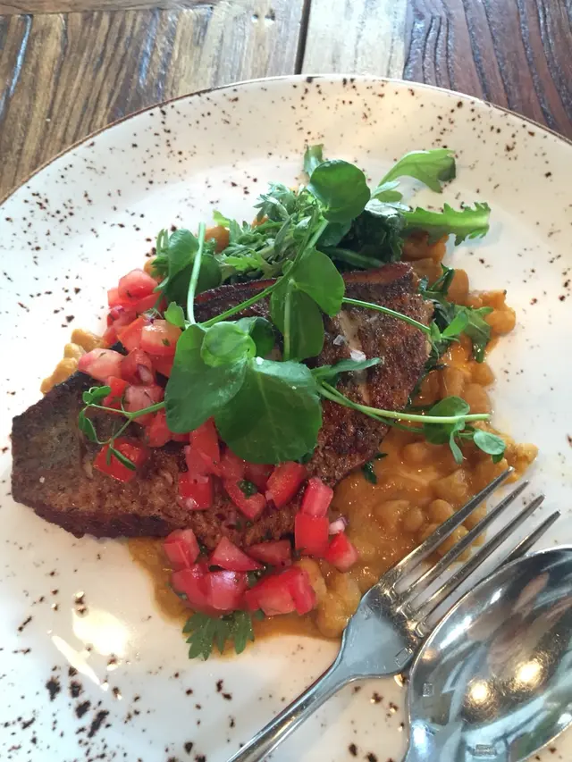 Pan fried fish of the day / cherry tomatoes on white bean masala