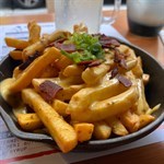 Fries  with  bacon  bits,  cheese  and  peri  peri  sauce  