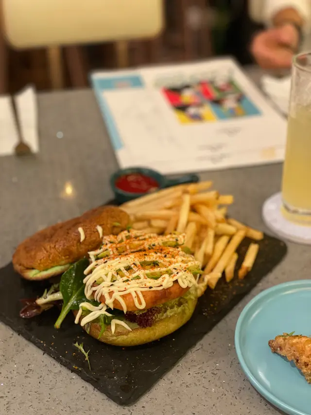 Pandan  pineapple  bun  veggie  burger  w/  tofu  patty  and  avocado  