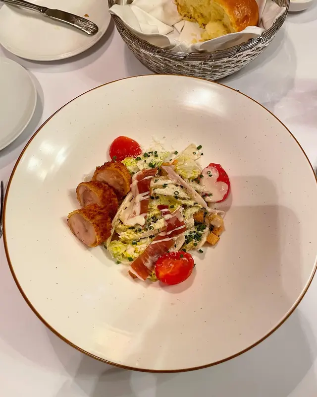 Chicken Caesar salad, croutons, bacon Parmesan cheese 