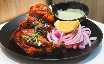 Tandoori Chicken  Chargrilled chicken with homemade Indian spices and yogurt