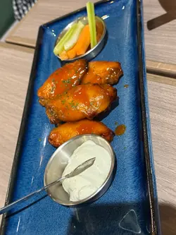 Rustic buffalo wings with blue cheese sauce